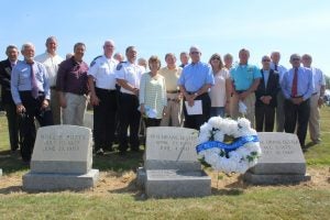 Local and locally connected residents, including Batesville Police Chief Tony Jones (in white uniform shirt at left) and (right from Jones) assistant police chief Jimmy McCloud, George Caffey, Robbie Knotts, Batesville Mayor Jerry Autrey, Johnny Nelson, George Lester, Betty Jane Billingsley, Sheriff Dennis Darby and Mike Slaughter, joined active and retired FBI personnel Thursday at Batesville Magnolia Cemetery to honor the memory of Drane Lester, a Batesville native and former agent who coined the FBI motto, “Fidelity, Bravery, Integrity.”  Photo by John Howell 
