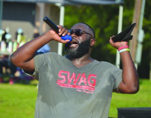 Alexander Sanford sings a gospel song during last month’s “beach bash” sponsored by Greater Impact youth ministry held at Grenada Lake. 