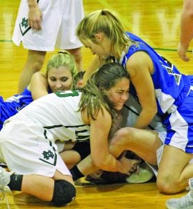 North Delta varsity’s Isabella Morrow (front center) helps out teammate Maci Kirkland under the pile as she is pinned down by the Indianola double team trying to get the loose ball Tuesday night. The Lady Green Wave sneaked a district win over Indianola 45-44 as Indianola was late with the shot at the buzzer. The Panolian photo by Glennie Pou