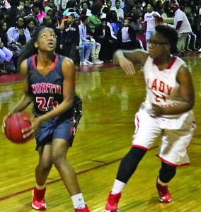 North Panola girls took on M. S. Palmer Dragons Friday night. Lady Cougar Monique Burnett (left) eyes the goal to score against a Lady Dragon. The Panolian photo by Ike House