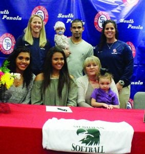 South Panola catcher Sydney Morgan (front, second from left) signed a national letter of intent to play softball at Meridian Community College. On hand to witness the signing Tuesday were family members and coaches (front, l. to r.) sister Chloe Morgan, Sydney, mother Regina Morgan with niece Ada; (back) coach Jimmye Anne Helms, brother Chris with niece Mia and head coach Ashleigh Hicks. The Panolian photo by Myra Bean