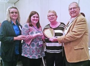 Panolian staff members (from left) Michelle Buckner, Maranda Johnson and Margaret Buntin accept the General Excellence Award at a luncheon during the Mississippi Press Association’s Mid-Winter Conference last Saturday in Jackson. Making the presentation is MPA president Don Norman. Panolian photo by Myra Bean