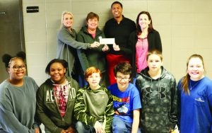 Mississippi Recycling Coalition awards Batesville Junior High Merit Class with a $1,000 Recycling Grant to help improve the school’s current recycling program. Students involved in the recycling program include (front row, from left) Maili Robinson, Sha’Niya Miles, Mathew Clark, Nathan Hamblin,  Joshua Towles, Leilyn Farris and not pictured is Hugh Covington. In the back, Panola County Administrator Kate Victor and Supervisor of the Solid Waste Department Jennifer Jackson hand over the check to BJH Principal Charles Stevens and Merit Teacher Emily Griste. The Panolian Photo by Ashley Crutcher