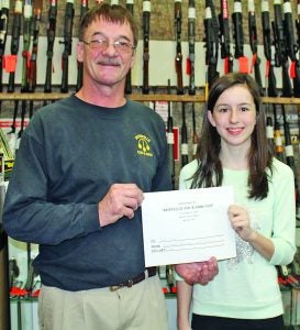 Carlee Griste (right) was the youth winner in the Batesville Gun & Pawn Shop/Panolian Big Buck Contest. She received a $250 gift certificate from Kelvin Marshall. Carlee brought down an eight-point buck on November 12.